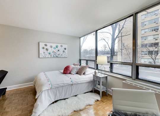 A bedroom with a large bed and a painting on the wall.