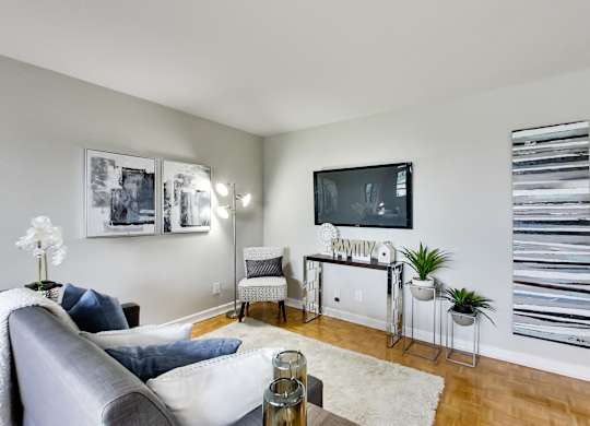 an apartment living room with a couch and a tv