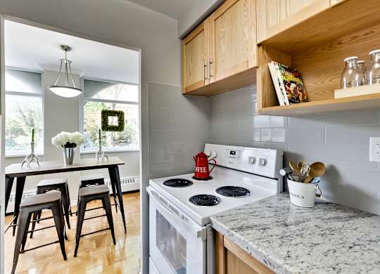 A kitchen with a white stove top oven and a counter top.