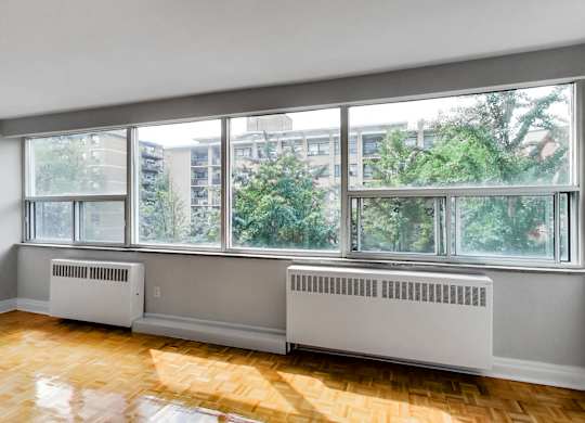 a living room with a large window and a wood floor