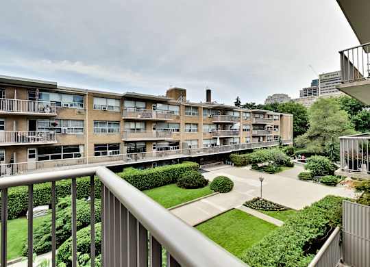 the view from the balcony of an apartment building in the city