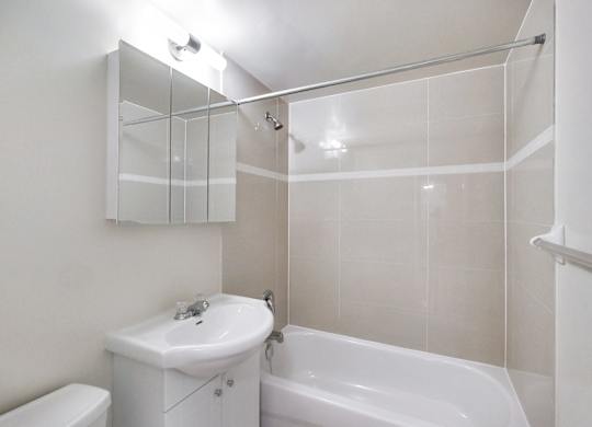 A white sink and toilet in a small bathroom.