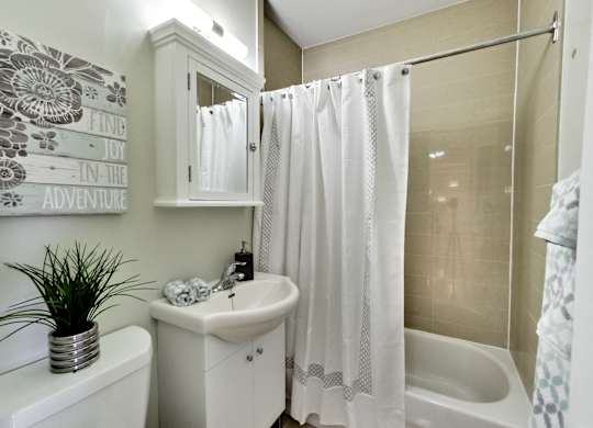 a bathroom with a sink and a tub and a shower