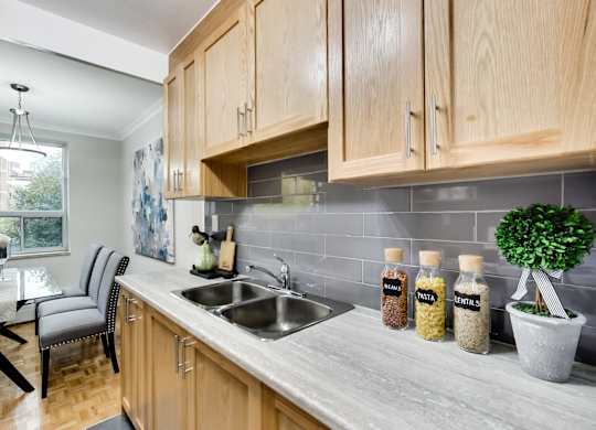 a kitchen with wooden cabinets and a sink and a window
