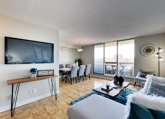 a living room with a couch and a tv and a dining room table