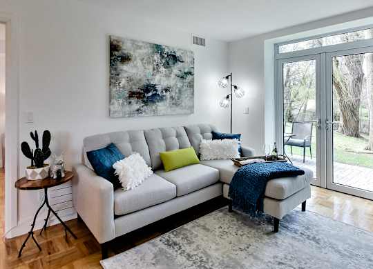 a living room with a couch and a chair and a rug