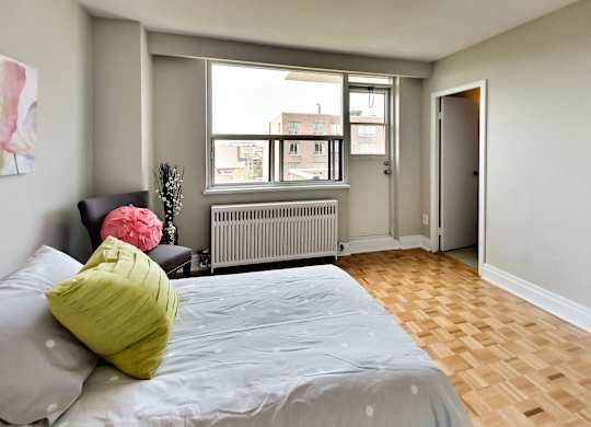 a bedroom with a large bed and a window