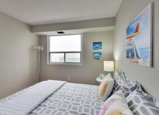 a bedroom with a large bed and a window