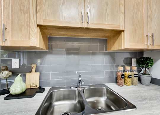a kitchen with a sink and wooden cabinets