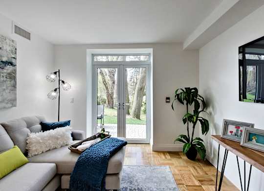 a living room with a couch and a door to a patio