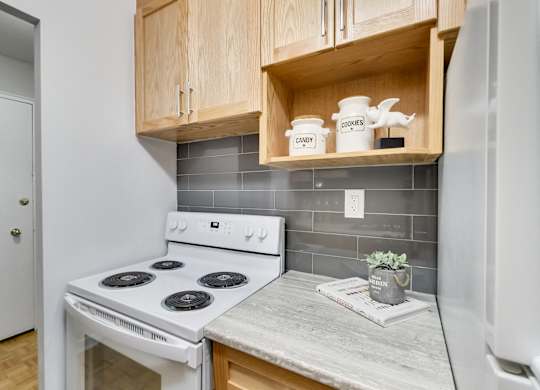 a kitchen with white appliances and wooden cabinets and a white stove