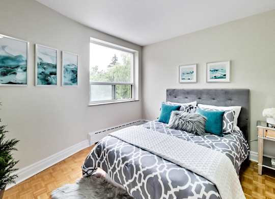 a bedroom with a bed and a window