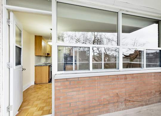 A view of a kitchen through a window.