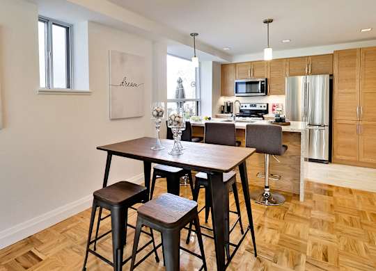 a kitchen and dining room with a wooden table and chairs