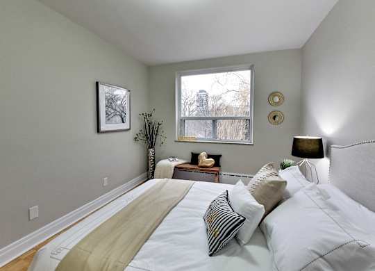 a bedroom with a large bed and a window