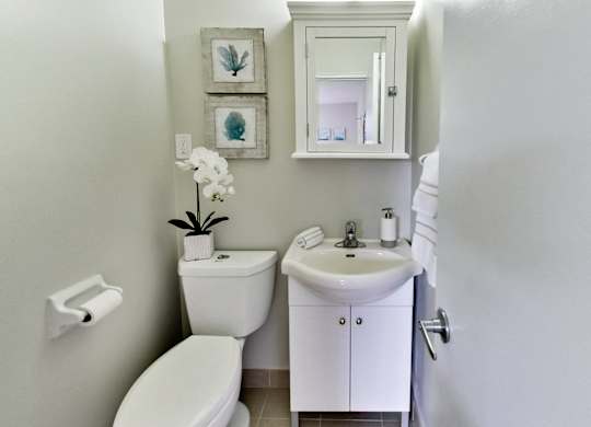 a small bathroom with a toilet sink and mirror