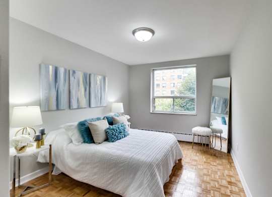 a bedroom with a large bed and a window