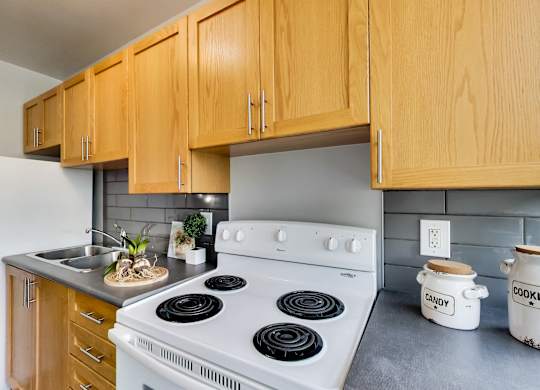 a kitchen with white appliances and wooden cabinets