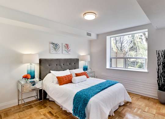 a bedroom with a large bed and a window