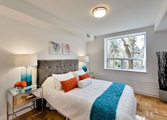 a bedroom with a large bed and a window