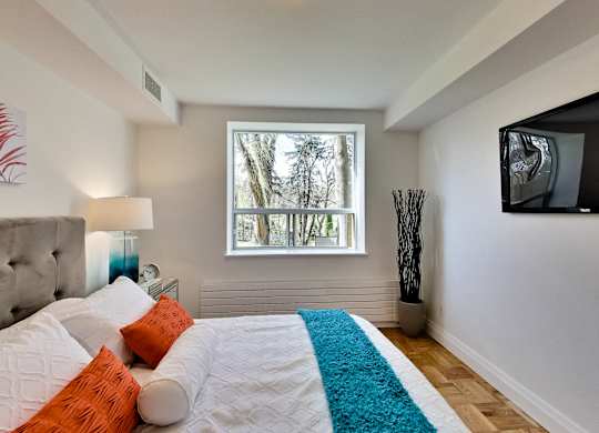 a bedroom with a large bed and a window