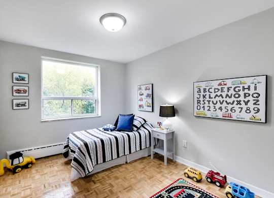 a bedroom with a bed and toys on the floor