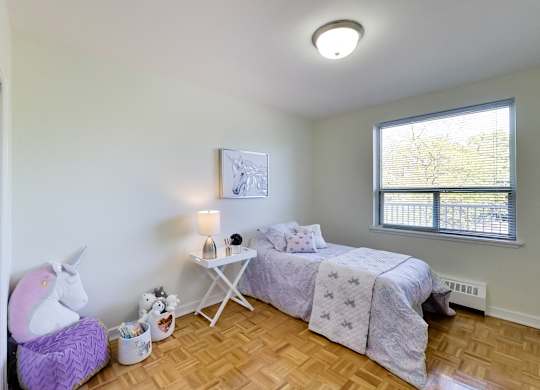 a bedroom with a bed and a unicorn chair