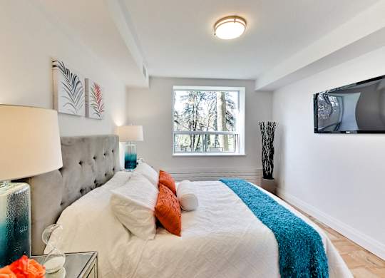 a bedroom with a large bed and a tv