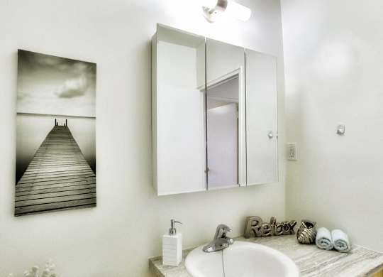 an image of a bathroom with a sink and a mirror
