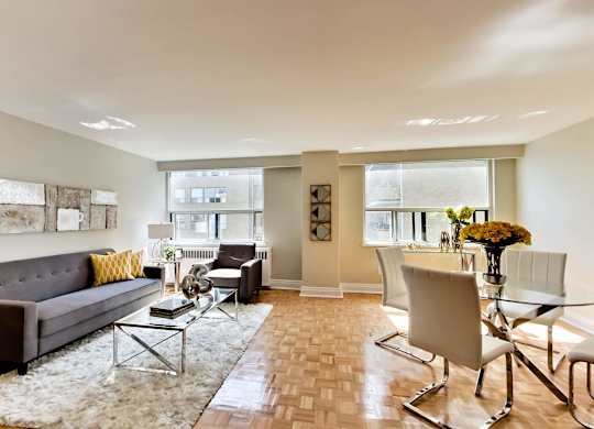 a living room with a couch and a dining room table