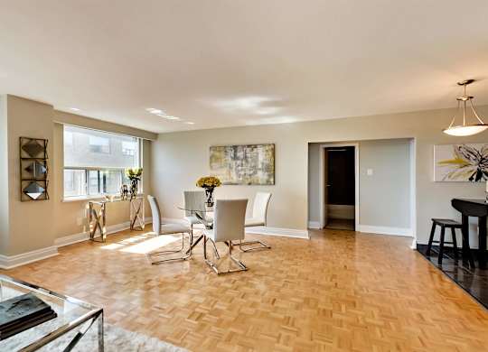 a dining room and living room with a table and chairs