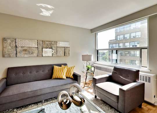 a living room with two couches and a large window