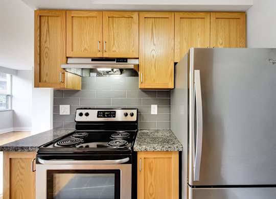 a kitchen with stainless steel appliances and wooden cabinets