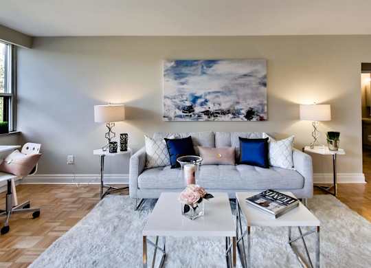 a living room with a couch and tables