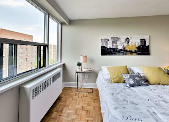 a bedroom with a bed and a window