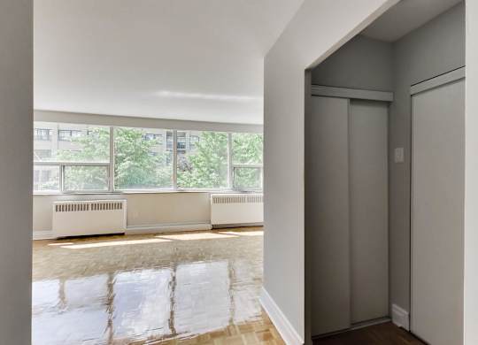 a living room with a large window and a door