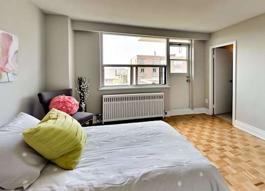 a bedroom with a large bed and a window