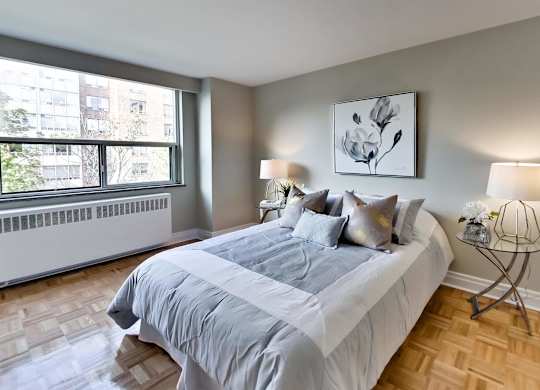 a bedroom with a large bed and a window
