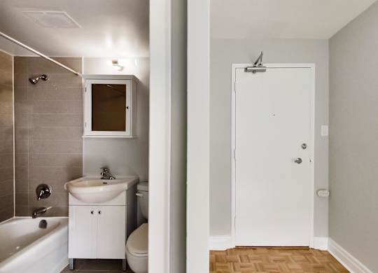 a small bathroom with a sink and a shower and a toilet