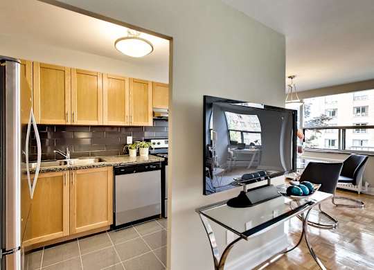 a kitchen and dining room with a tv on the wall