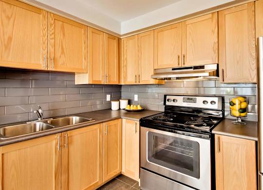 a kitchen with stainless steel appliances and wooden cabinets
