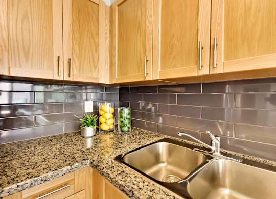 a kitchen with a sink and wooden cabinets