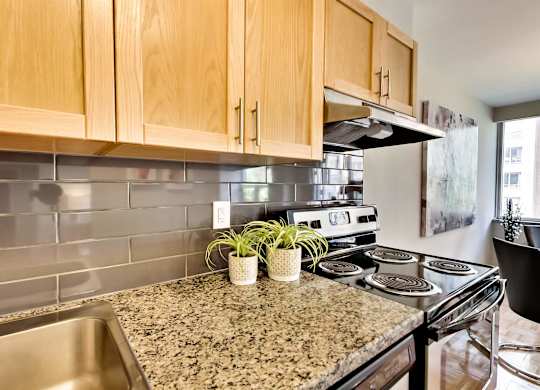 a kitchen with granite counter tops and a stove top oven