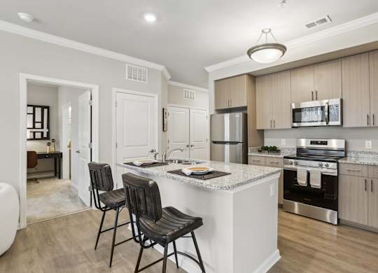 a designer kitchen with granite countertops and stainless steel appliances