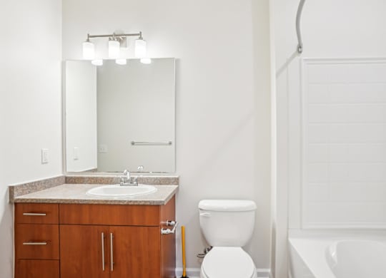 A white toilet sits next to a sink in a bathroom.