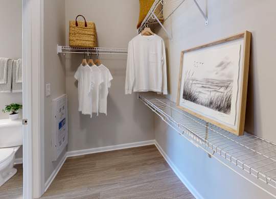 a large walk-in closet with racks and shelves