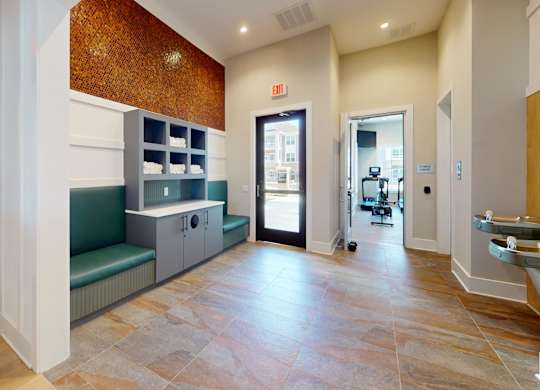 a clubhouse hallway leading to the 24-hour fitness center