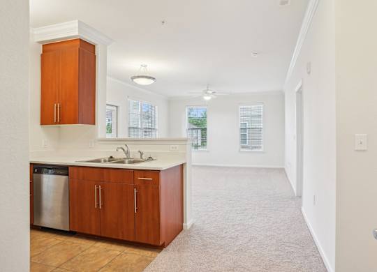 A kitchen with wooden cabinets and a sink.