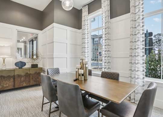 a private conference room with a table, seating and television