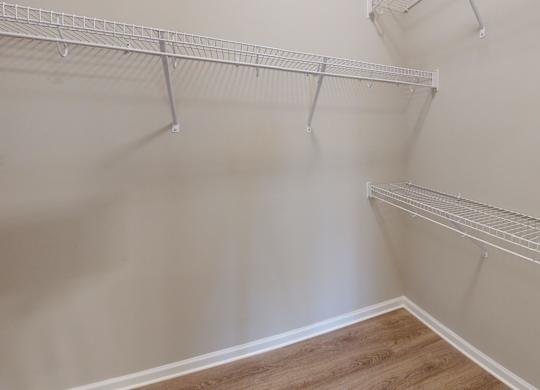 a walk-in closet with shelving